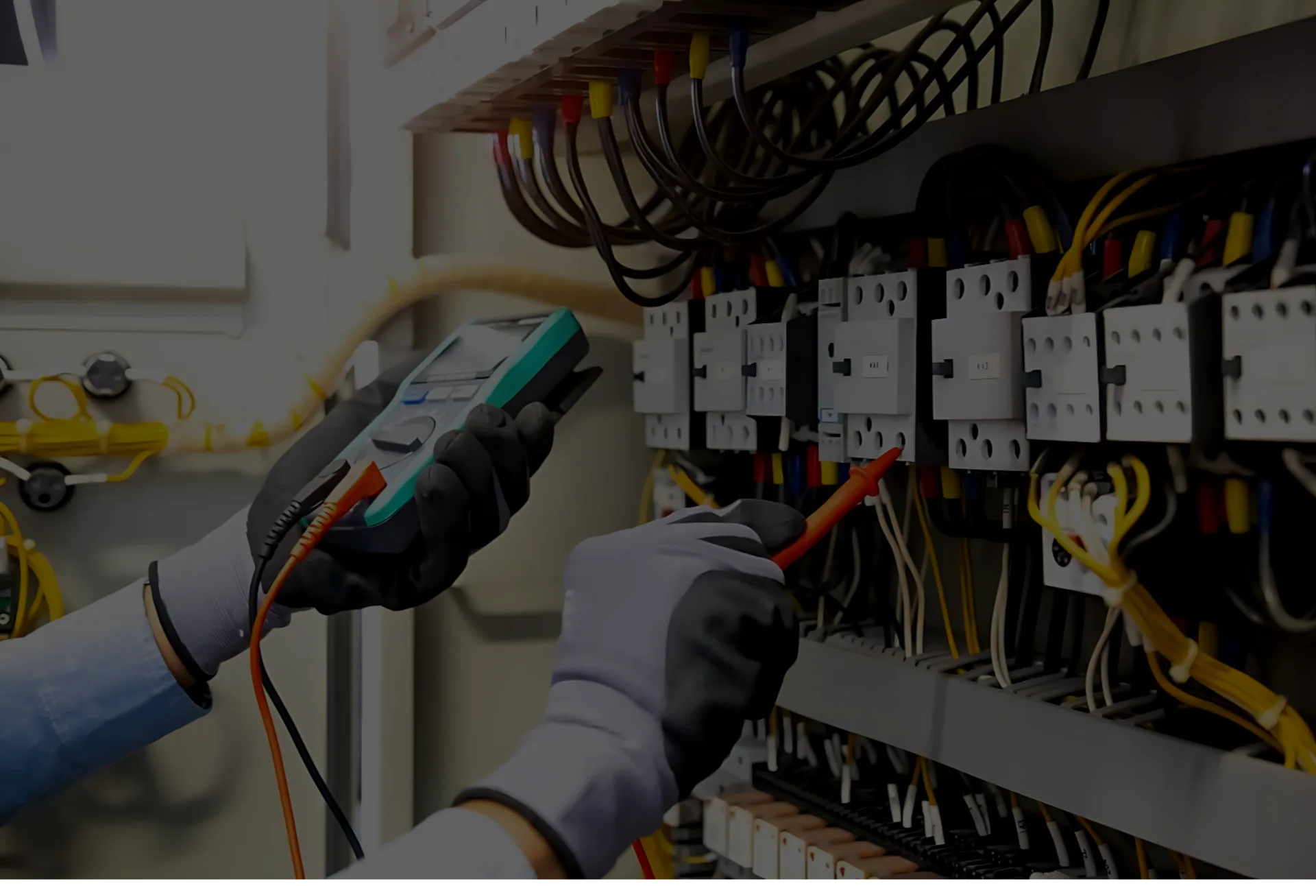 Technician testing control wiring with a multimeter