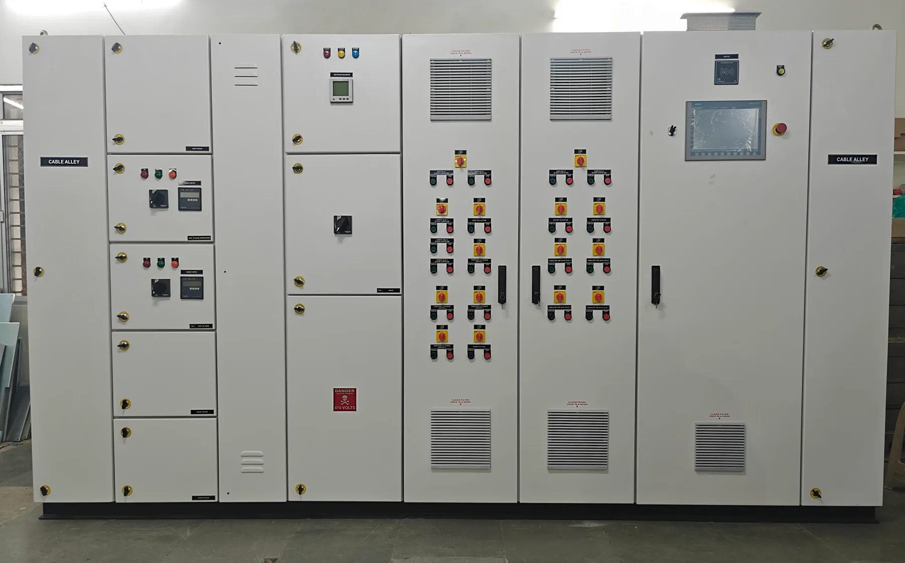 Row of PLC automation panels with HMI touch screen and control compartments